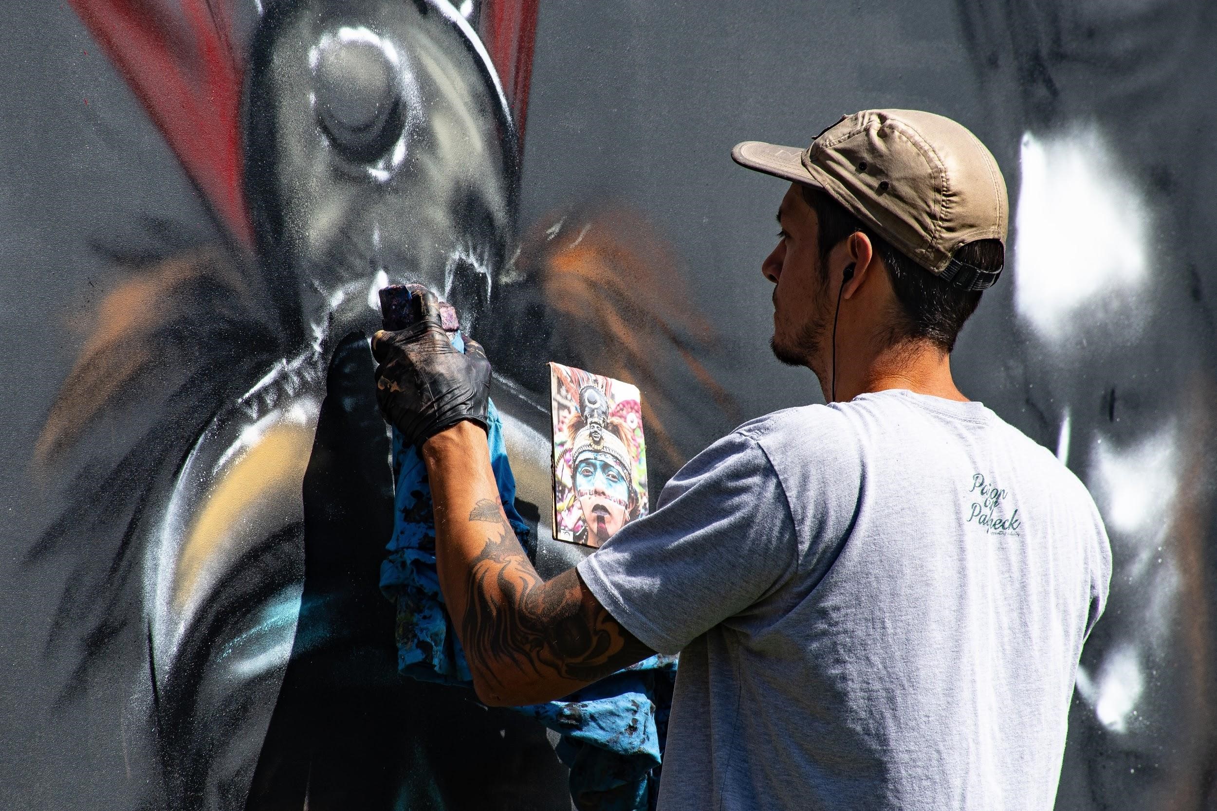 Famous street artists. Street artist painting.