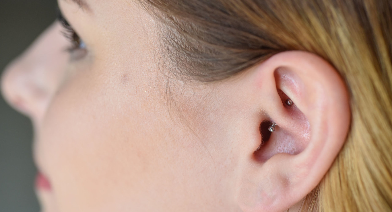 A guide for Daith Piercings. Woman with a daith piercing.