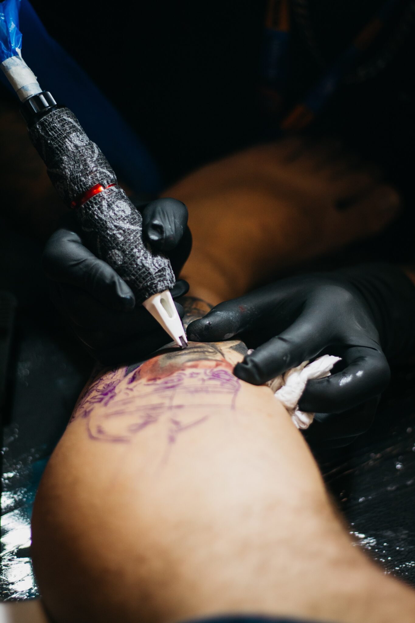 The best tattoo artists in the world. A tattooist doing a sleeve job.