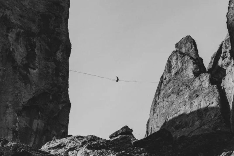 Highlining and Slacklining are balancing sports. Man practicing Highline between two peaks.