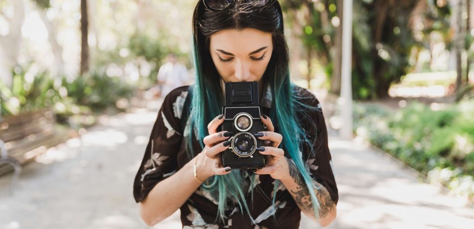 The most famous street photographers in the world. Young woman with a camera.