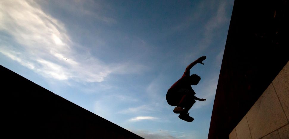 What is parkour? Young man practicing parkour.
