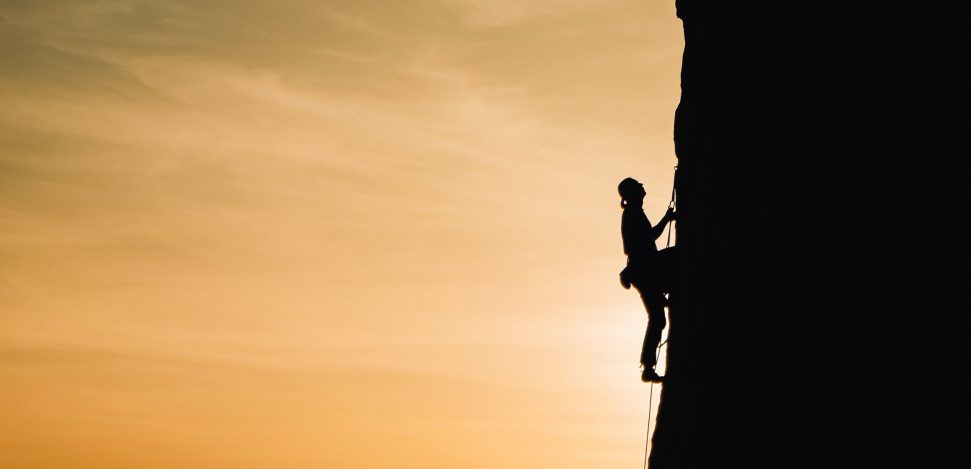 Climbing Workout: a person practising rock climbing.
