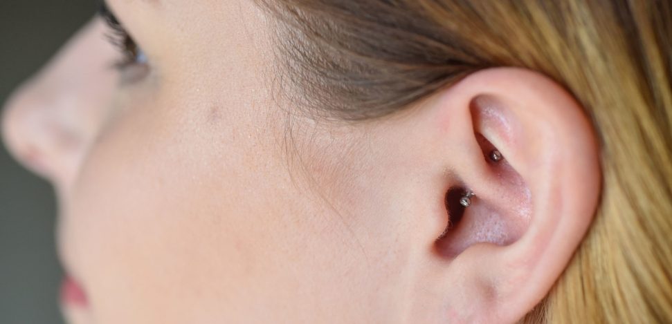 A guide for Daith Piercings. Woman with a daith piercing.