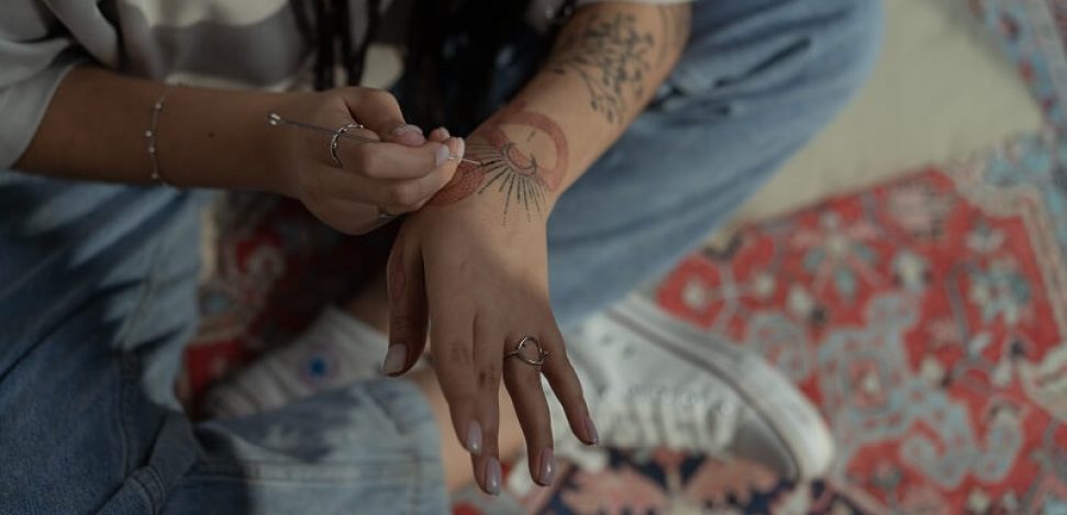 Discover more about the Hand poke tattoo.