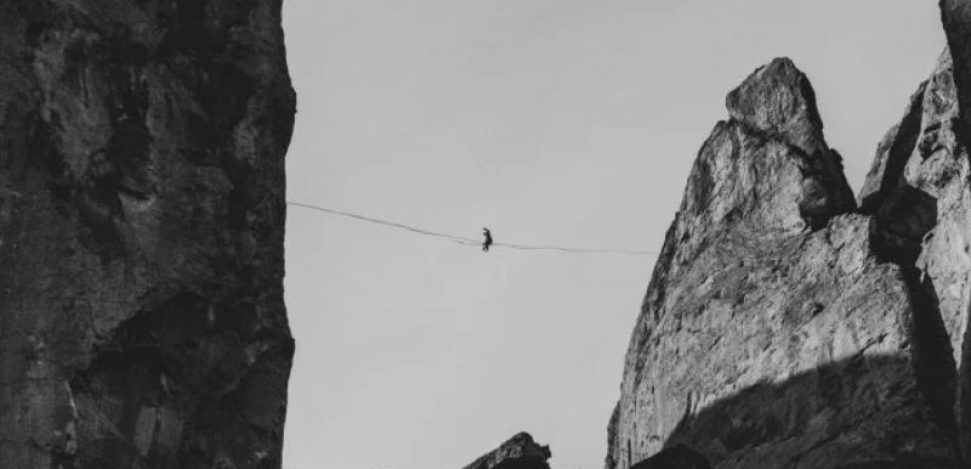 Highlining and Slacklining are balancing sports. Man practicing Highline between two peaks.
