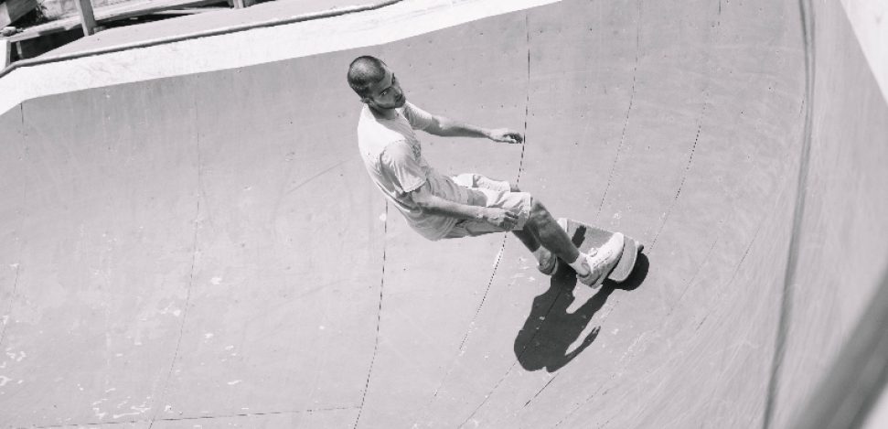 Old school skateboarder performing tricks on a vintage skateboard